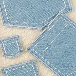 Set of light blue denim faux pocket patches with white stitching for apparel repair