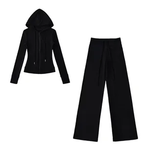 Front view of black thermal yoga set featuring zip-up hoodie and wide-leg trousers