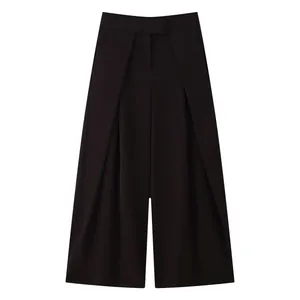 Detailed view of elegant dark wide-leg trousers with draped design and stylish high waist