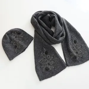 Gray knit beanie and scarf set with intricate floral bead embroidery for winter fashion