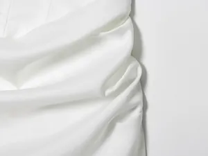 Nahaufnahme der weißen Stoffstruktur eines stilvollen, ärmellosen Bodycon-Kleides