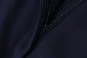Macro view of the high-quality smooth zipper and durable navy fabric of casual pants