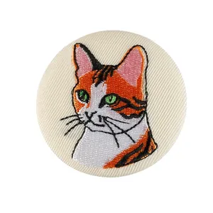 Detailed orange and white embroidered cat patch badge accessory for bags and clothes