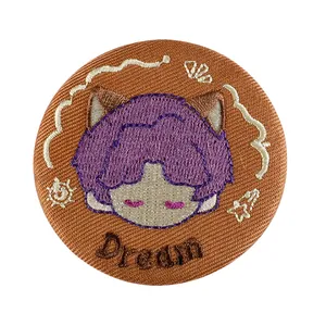 Embroidered cartoon patch badge with purple hair character and Dream text