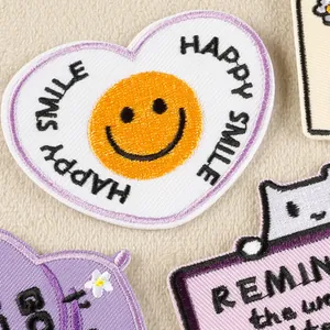 Colorful heart-shaped embroidered patches with smiley face and floral designs