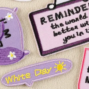 Detailed view of colorful embroidered patches with floral designs and English text.