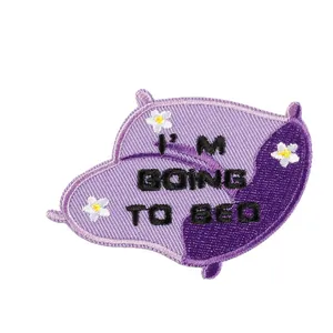 Embroidered purple pillow shaped patch featuring flowers and I'm Going To Bed text