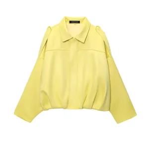 Detalle de la estructura y efecto ante de la chaqueta bomber amarilla para mujer.