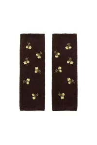 Detailed macro view of dark brown knit arm warmers with yellow floral embroidery