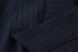 Macro view of navy pinstripe fabric and high-quality stitching on wide-leg pants