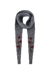 Detailed view of gray knitted scarf with embroidered red roses and leaves