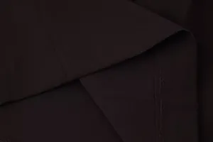 Macro view showing the high-quality stitching and texture of black wide-leg pants