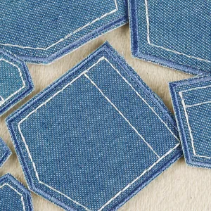 Set of dark blue denim iron-on patches in fake pocket design with white stitching