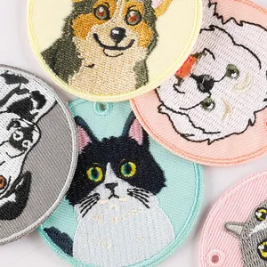 Cute embroidered pet patches featuring cartoon cat and dog faces for keychains and bags