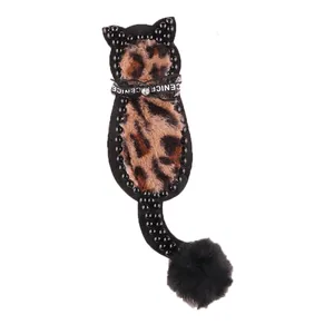 Handmade leopard print cat fabric patch with black beaded border and pom-pom tail
