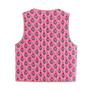 Close-up back view of a pink quilted vest featuring a floral print and striped trim.