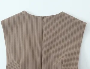 Macro view of back neckline featuring an invisible zipper on a brown striped mini dress