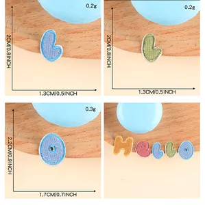 Vista dettagliata di toppe ricamate a forma di lettere colorate con dimensioni e peso esatti