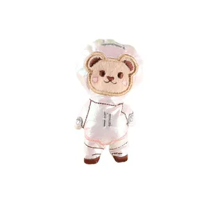 Cute embroidered bear astronaut plush accessory for bags and clothing decoration.