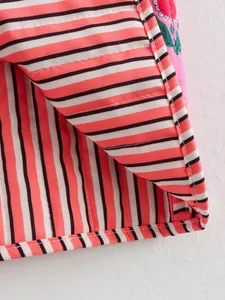 Close-up of pink and white striped fabric on reversible cotton-padded vest