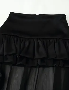 Close-up detail showing the elegant tiered ruffles of this black chiffon maxi skirt design
