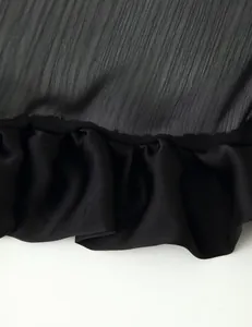 Detailed close-up view of the black multi-layer ruffle hem on a summer long tail skirt