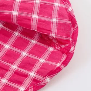 Close-up of pink checkered midi skirt showing stitching and fabric texture