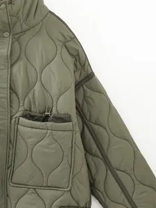 Close-up detail of olive green winter quilted jacket with stylish wavy stitching pattern