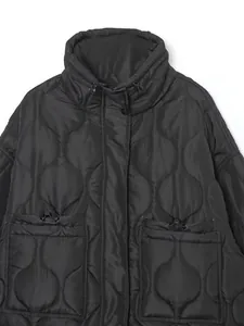 Close-up of black quilted puffer jacket with stand collar and large pockets