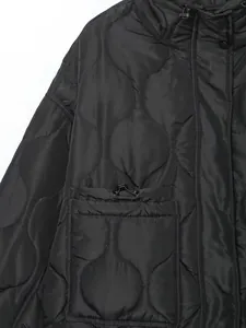 Close-up of black onion-quilted jacket featuring adjustable drawstring pocket
