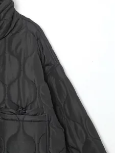 Close-up view of black quilted puffer jacket with stand collar and drawstring detail