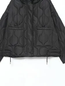 Detailed view of black onion-quilted puffer jacket with large patch pockets and drawstrings.