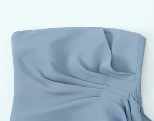 Close-up detail showing the elegant pleated texture of a dusty blue slim-fit tube top.