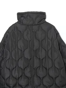 Detailed view of the onion quilting pattern and stand-up collar on a black puffer jacket