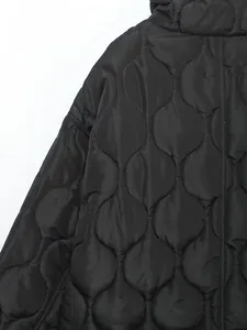 Detailed macro view showing the unique onion quilting pattern on a black winter jacket
