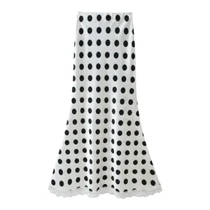 Elegant white high-waist maxi skirt with black polka dots and delicate lace hem detail
