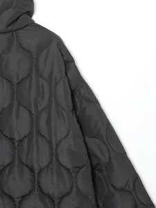 Detailed macro view showing the onion quilt pattern on a black winter padded jacket