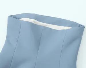 Macro detail view of a blue elegant garment waist featuring hidden side zipper and white lining