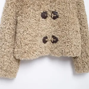 Chic camel faux lamb wool cropped jacket featuring stylish metal buckle closures
