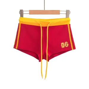 Rode sportieve korte broek met gele bies en 06-opdruk, trendy zomerse sportkleding