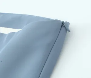 Macro view of high-quality invisible zipper on light blue pleated women's clothing set