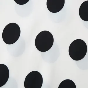 Macro view of classic black polka dot pattern on white elegant chiffon fabric for women