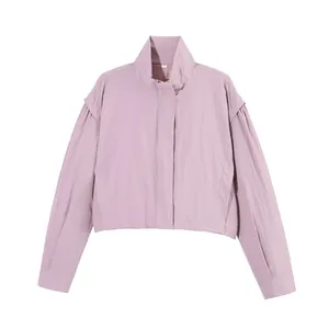Detail view of mauve stand-up collar jacket with lightweight fabric texture