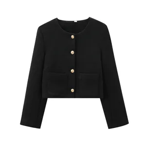 Detailed view of a classic black tweed cropped jacket with gold buttons and crew neck