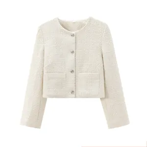 Macro detail of a cream white tweed cropped jacket featuring silver buttons and pockets