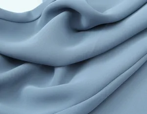 Close-up detail of smooth dusty blue fabric texture and elegant draping for women's set