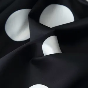 Close-up view of elegant black and white polka dot fabric texture for women's set