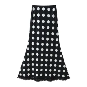 Detailed view of high waisted black and white polka dot maxi skirt featuring lace trim