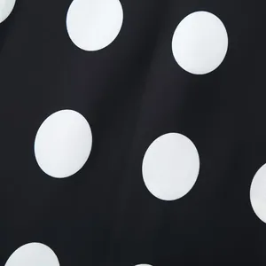 Macro view showing the high-quality black fabric detail with white polka dot pattern design