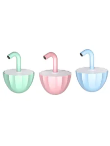 Detail of three colorful umbrella-shaped electric tumbler cat toys on white background